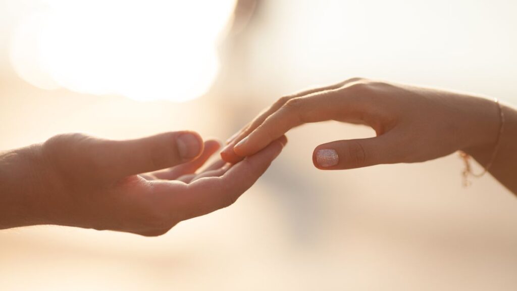 Physical Contact: man and woman touching hands.