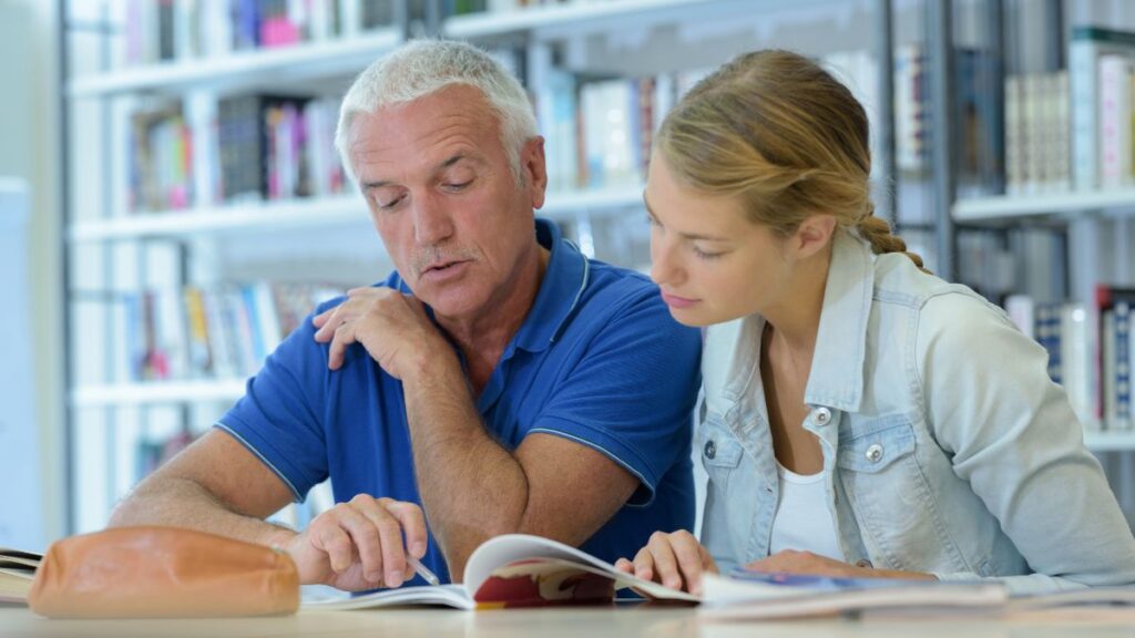 Reading Aloud man reading to woman in the library