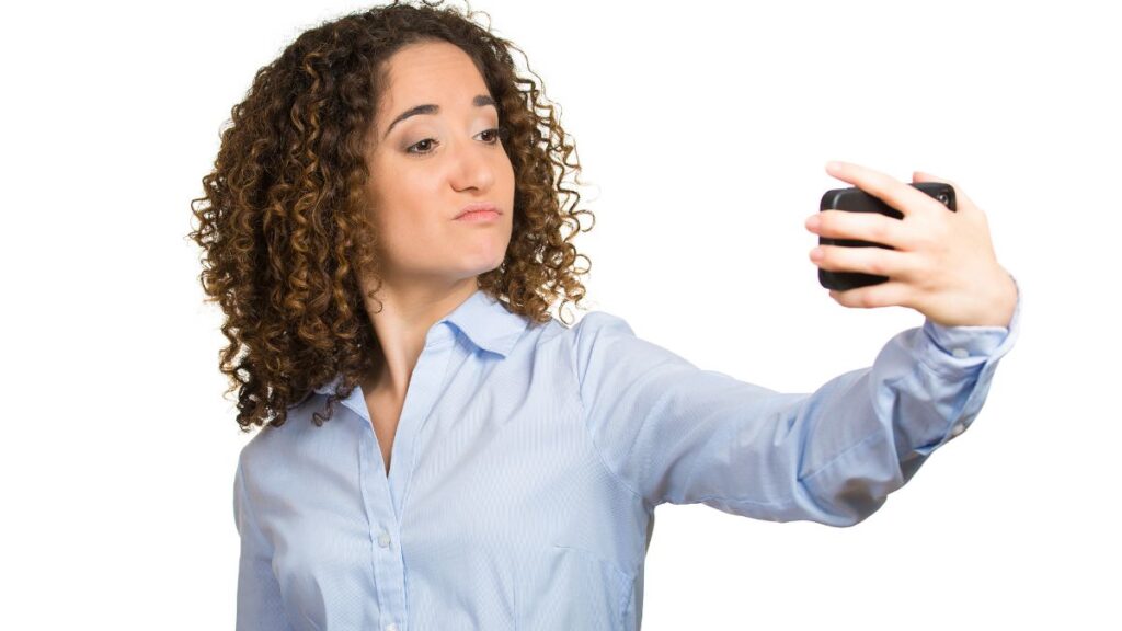 Self-Centered woman looking selfishly at her phone.