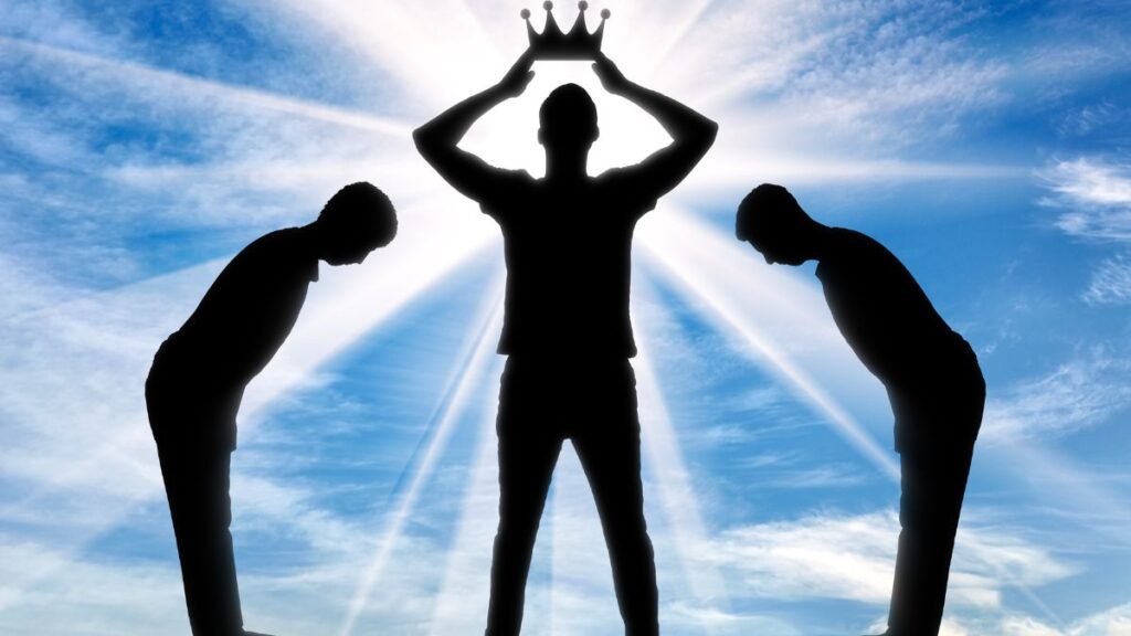 Man standing in shadow between two people bowing