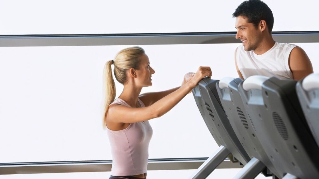 Social Interactions man and woman talking at the gym