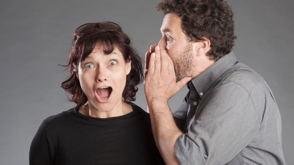 Spoiling Shows a man whispering to a woman and the woman looking surprised