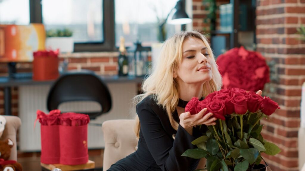 Surprises: woman smelling roses in an office.