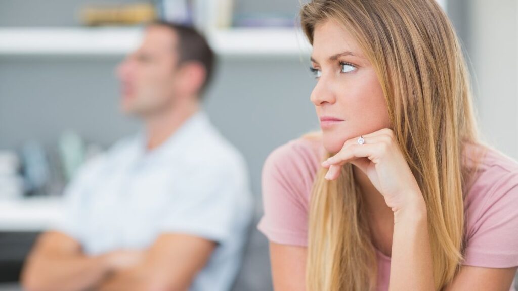 unhappy couple sitting apart on the couch