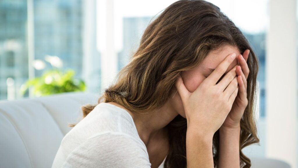 Upset woman crying into her hands