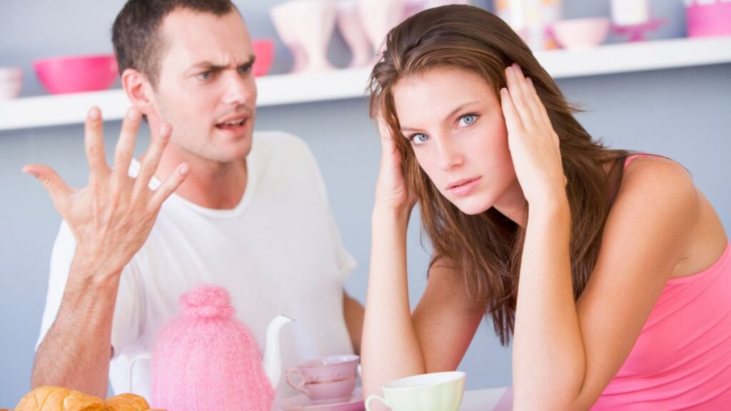 Woman and man arguing. man looking at her confused and woman looking stressed