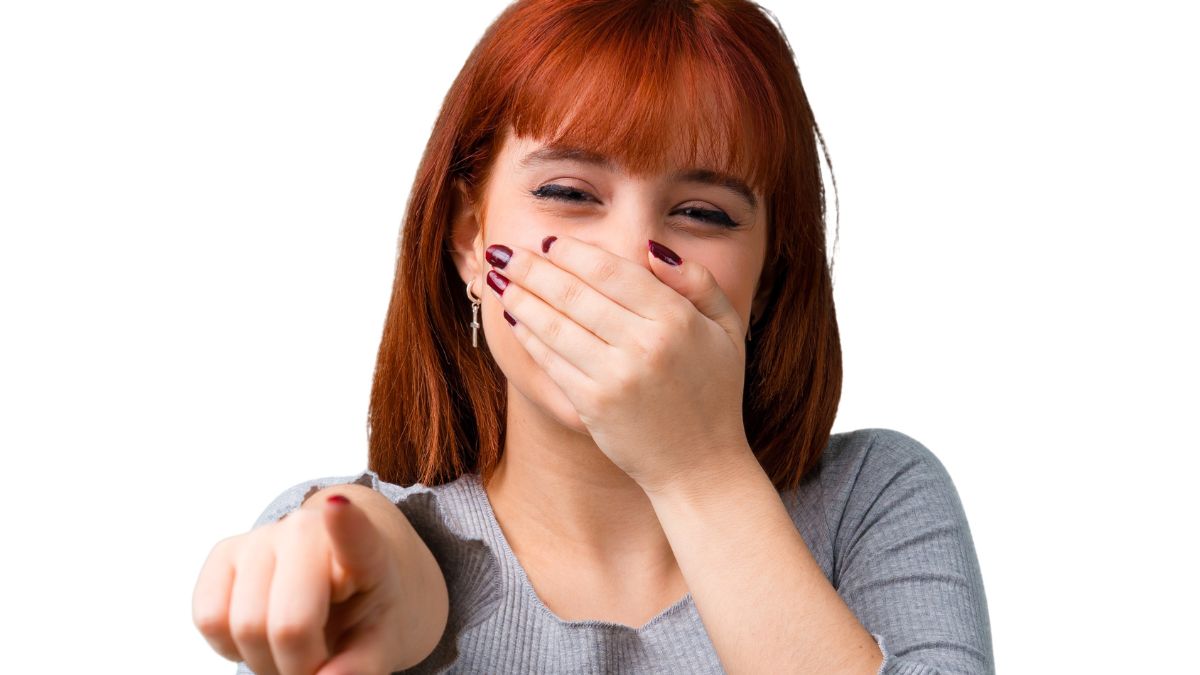 woman covering her mouth laughing