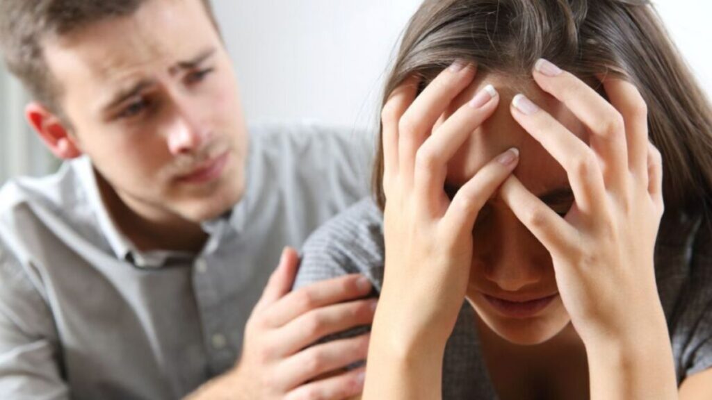 woman crying and man comforting her 