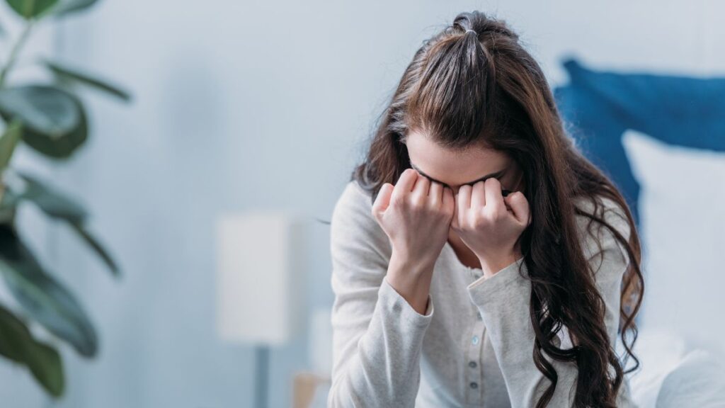 Woman crying into her hands