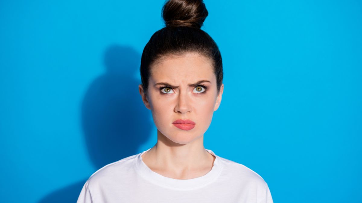 woman hair in a bun looking angry