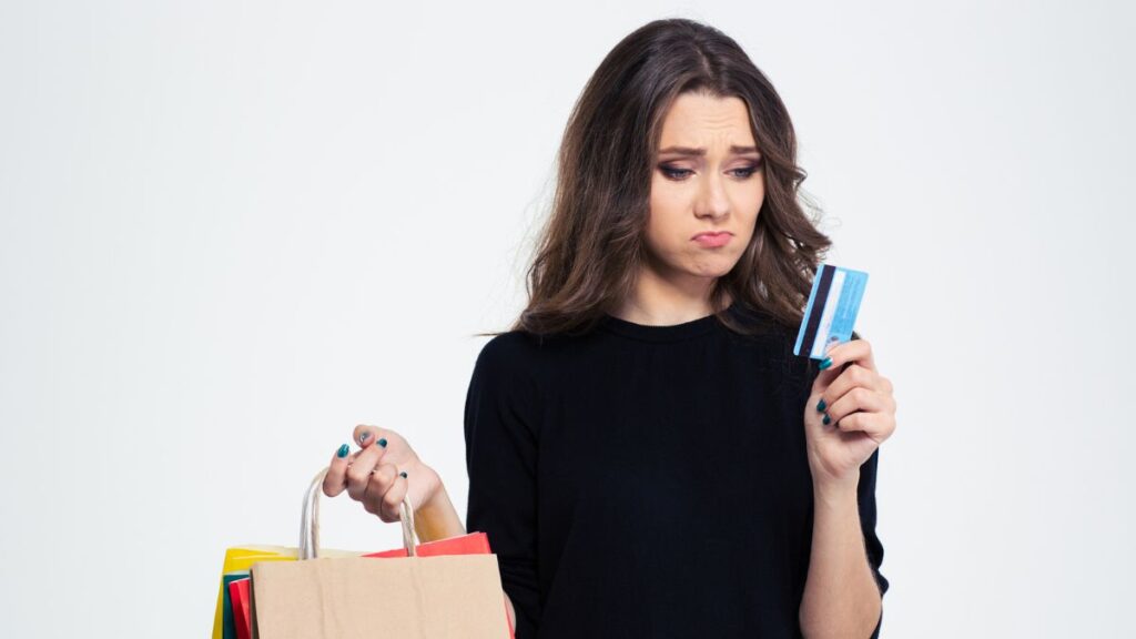 Woman holding a credit card and a shopping bag