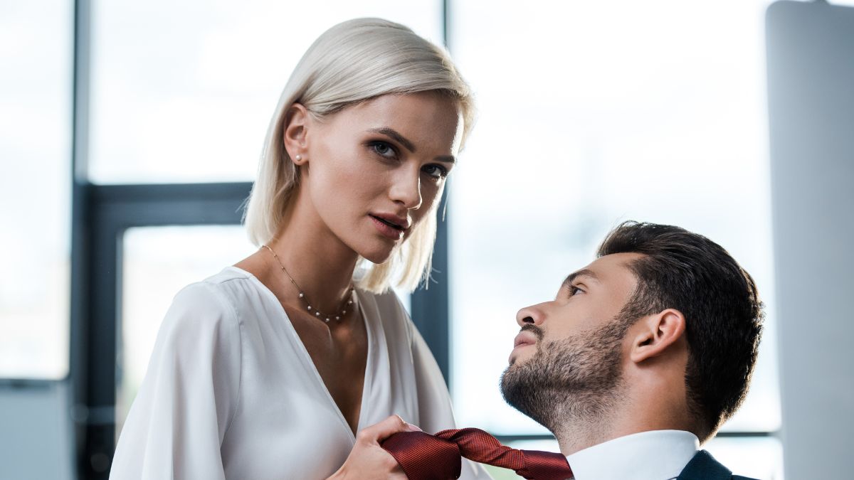 woman holding a mans tie getting close