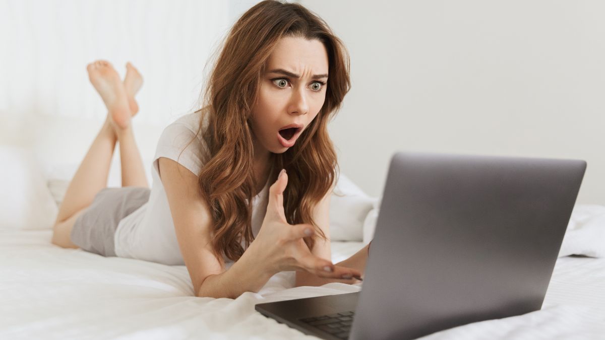 Woman looking at her computer in shock