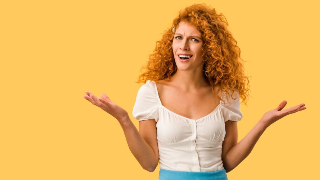 woman looking confused with her hands out