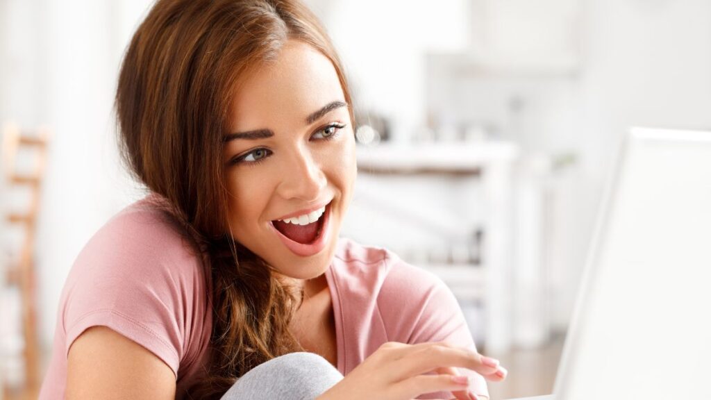 woman looking happy on the computer