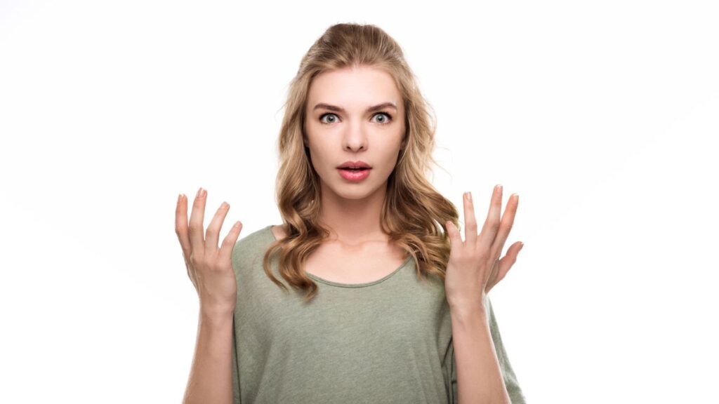 Woman looking surprised, wearing a green shirt