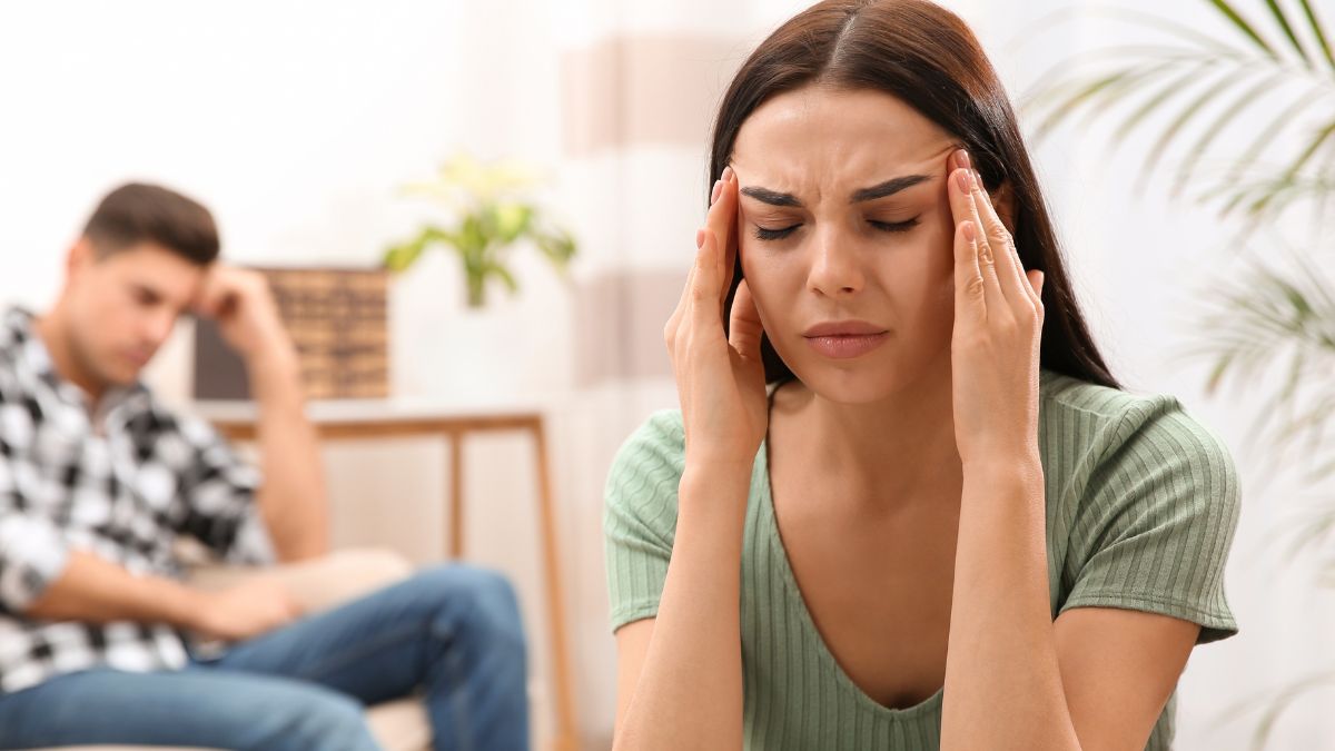 Woman looking upset, man behind her