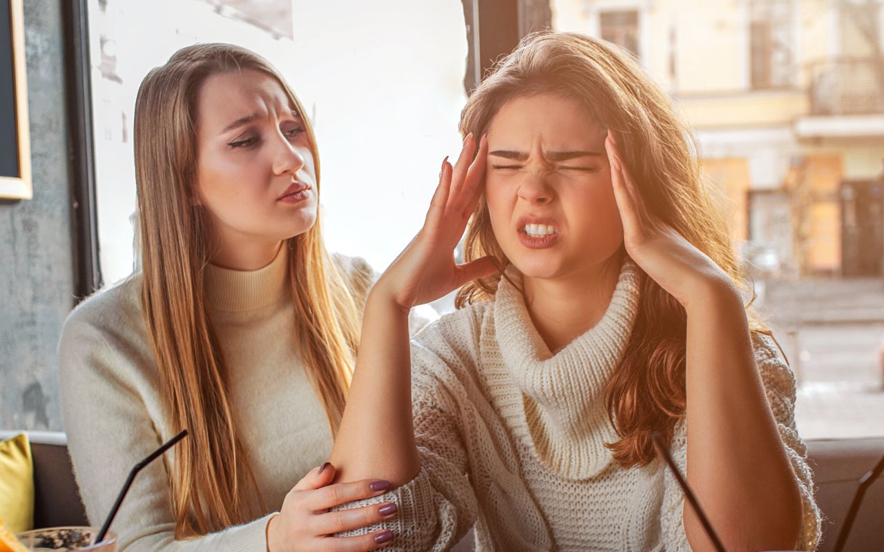 woman looking upset with a friend comforting her