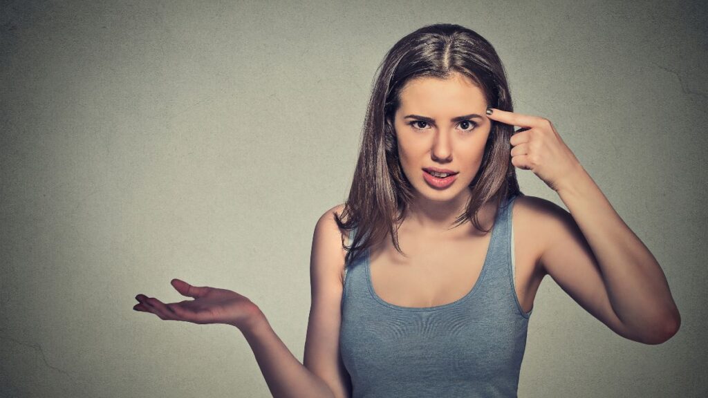 woman pointing to her head for common sense