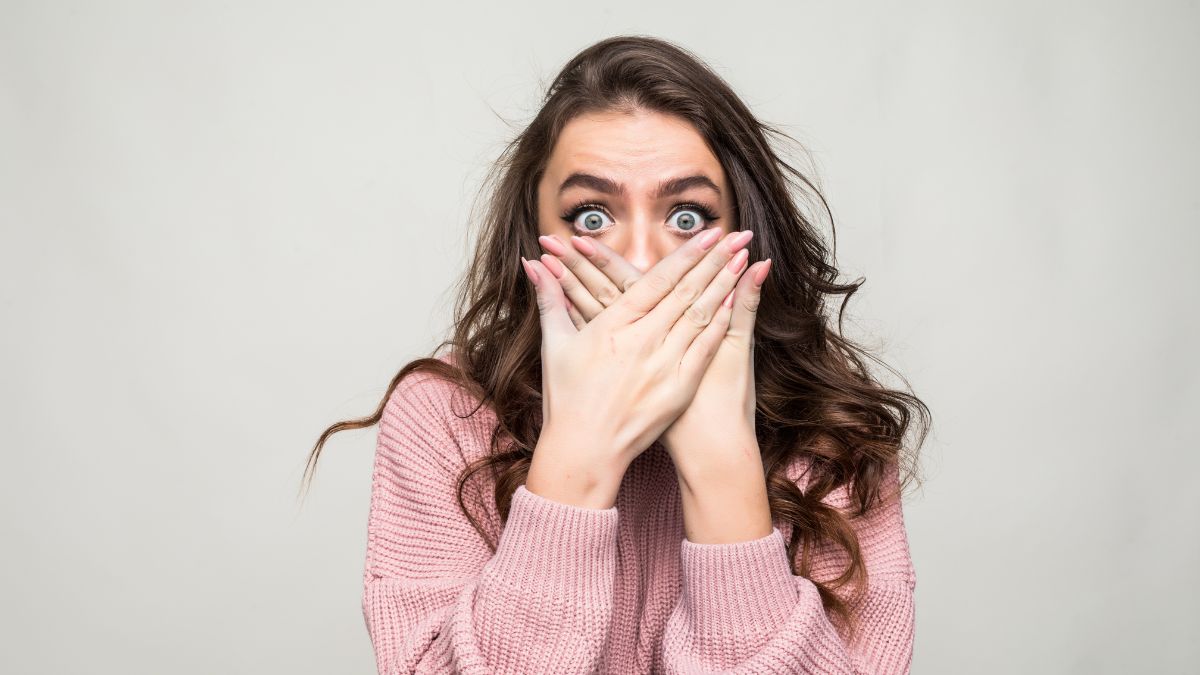 Woman shocked covering her mouth