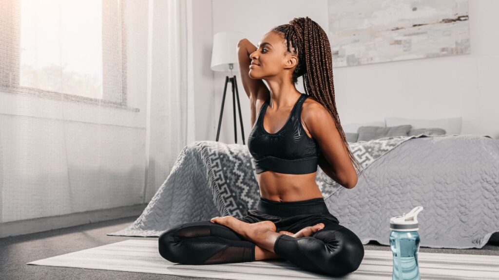 woman sitting in yoga position smiling