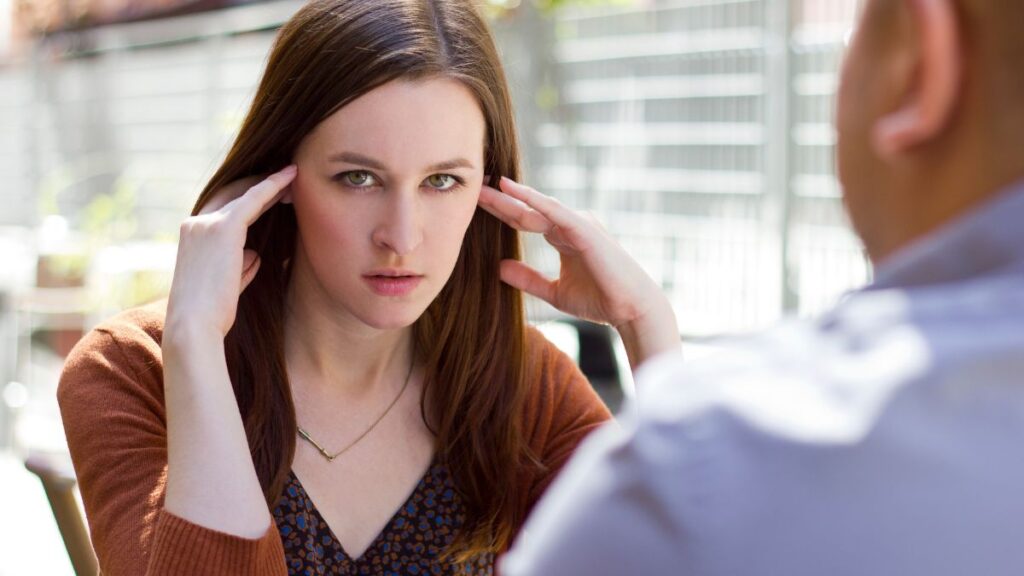 woman sitting on a date looking irritated