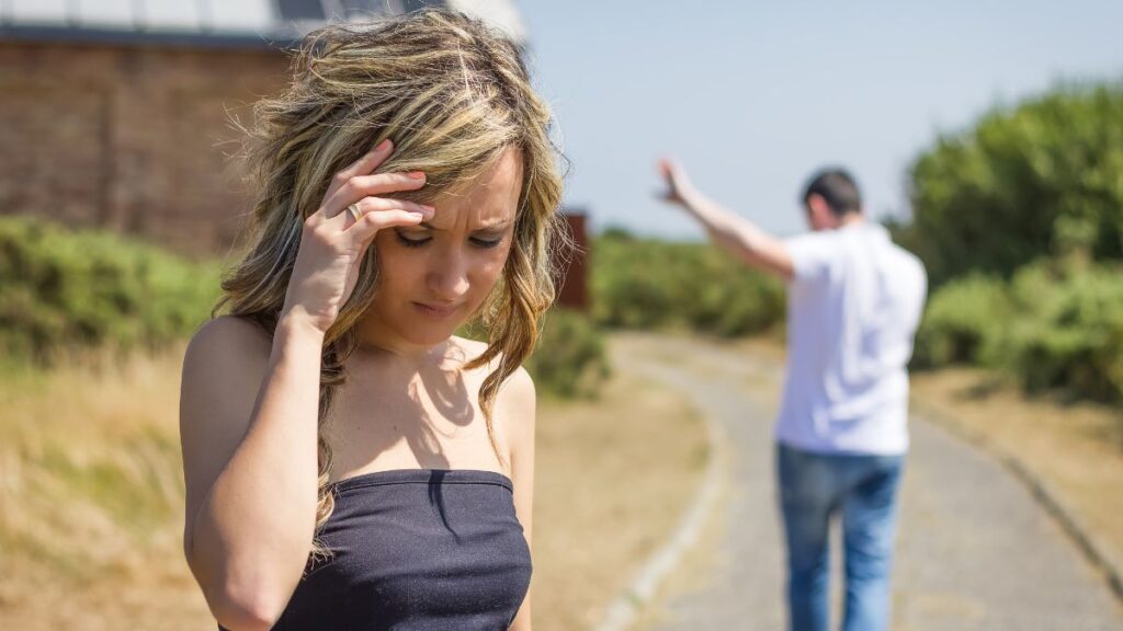 woman standing upset man walking away