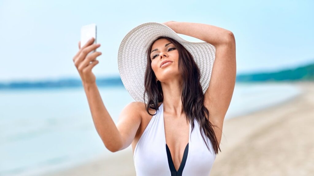 woman taking a sexy selfie on the beach