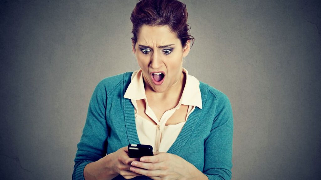 woman upset looking at phone