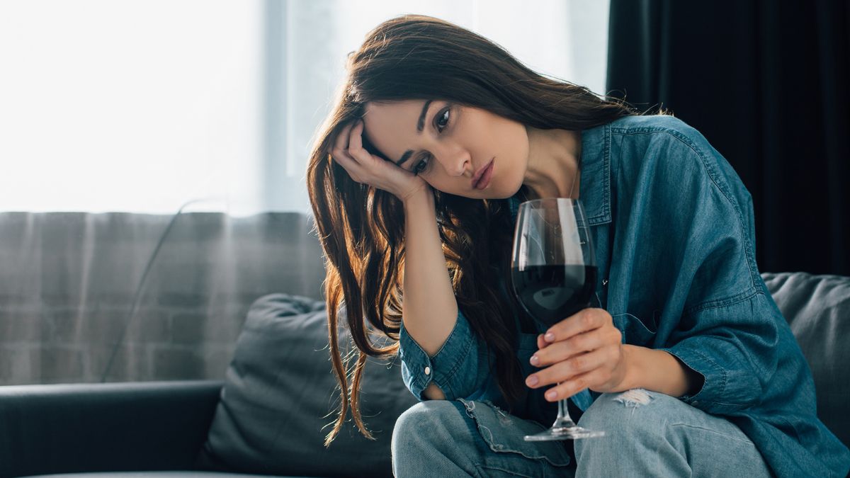 Woman with a glass of wine, looking down