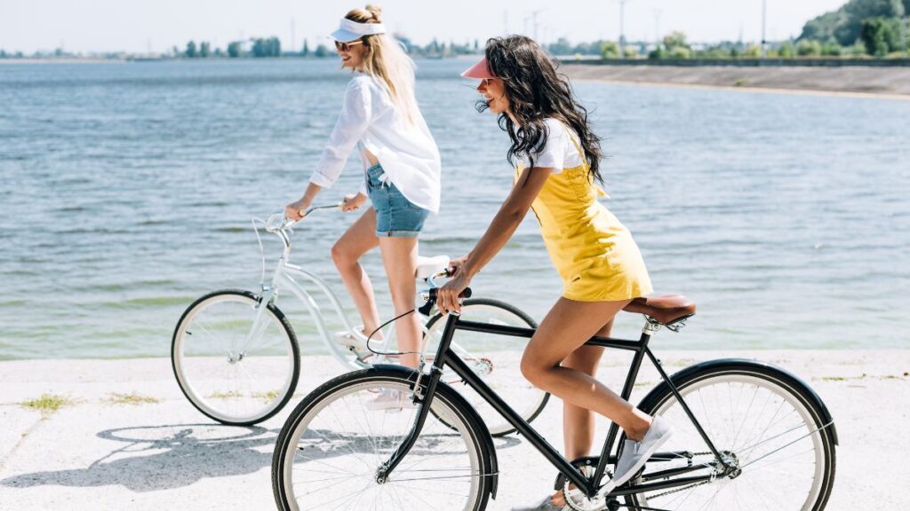 Women on Bicycles two women riding bikes at the beach