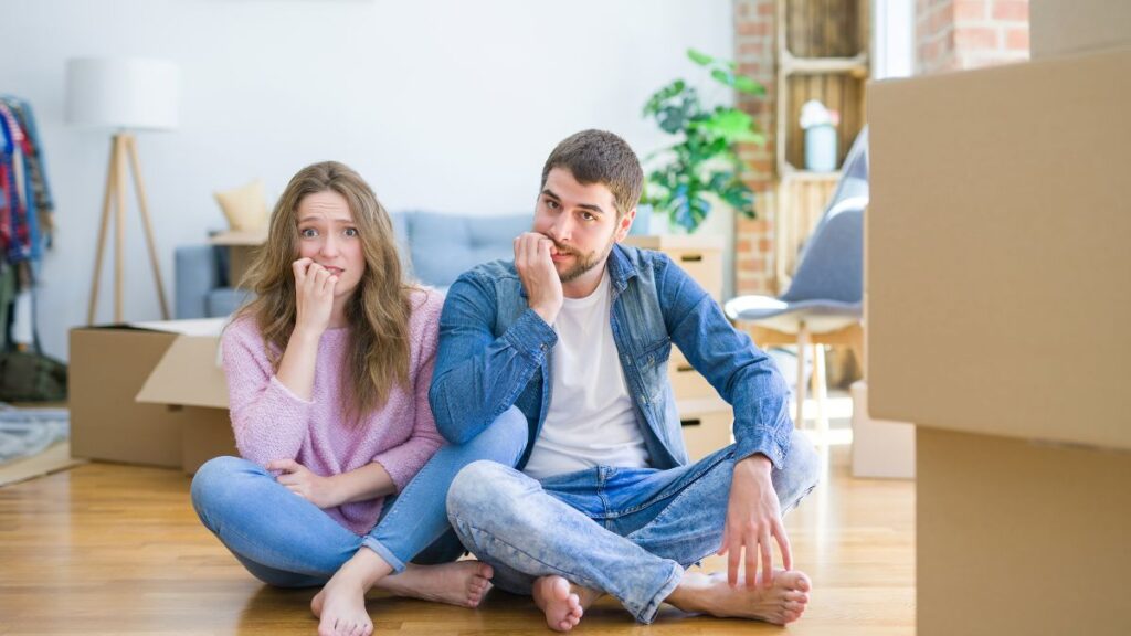 worried couple sitting on the floor