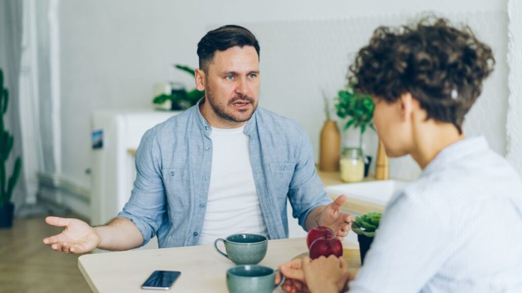 You Need to Change:man and woman sitting at a table looking upset.