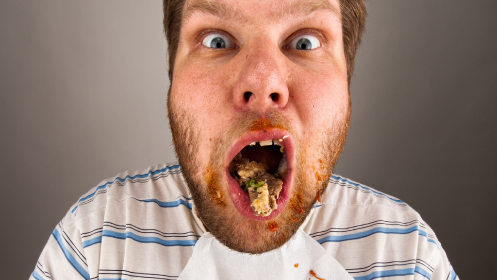 Man chewing food with mouth open