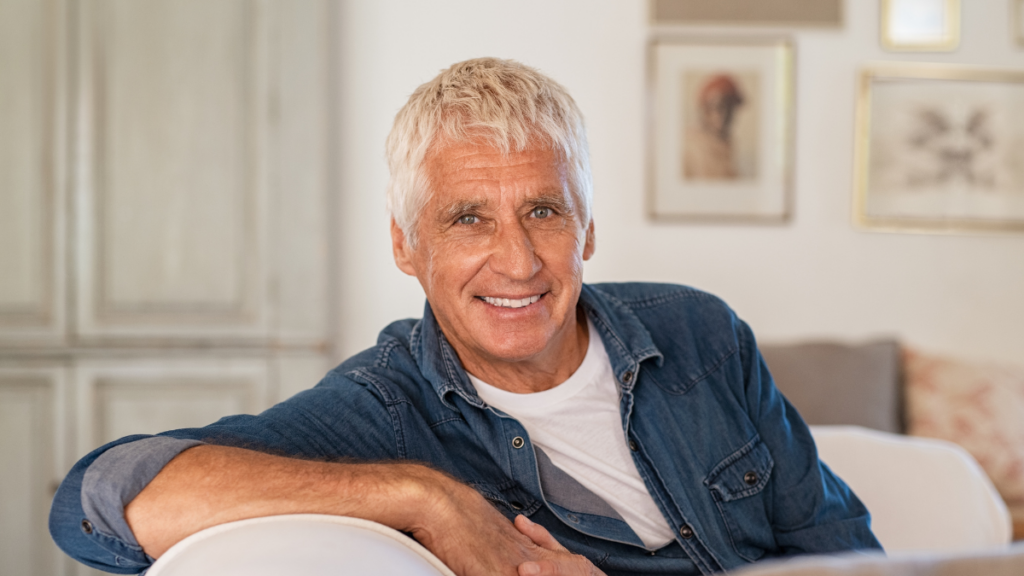 smiling man relaxing on sofa