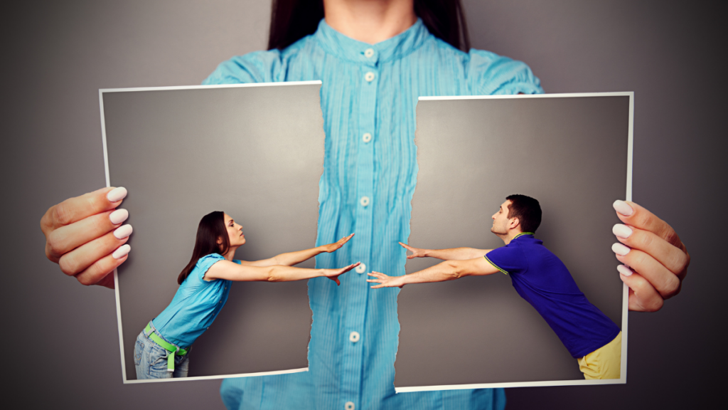 a woman holding a picture of two people trying to reach each other