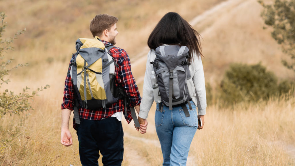 couple hiking in field