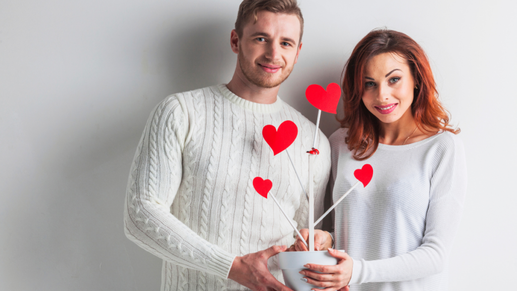 couple holding tree with hearts