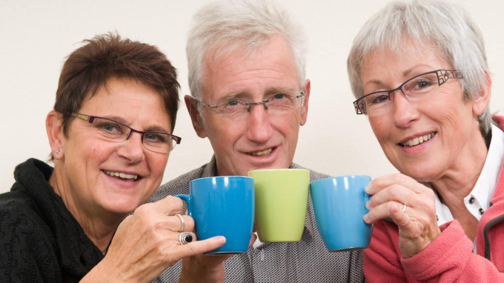 3 older people drinking coffee