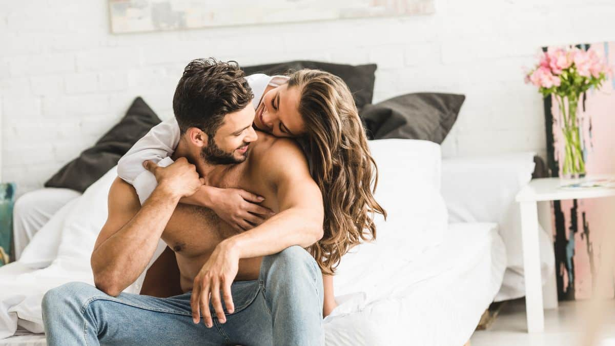 happy couple hugging on the bed