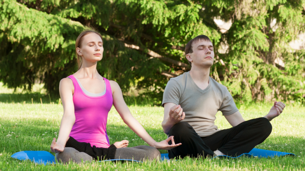 man and woman doing yoga