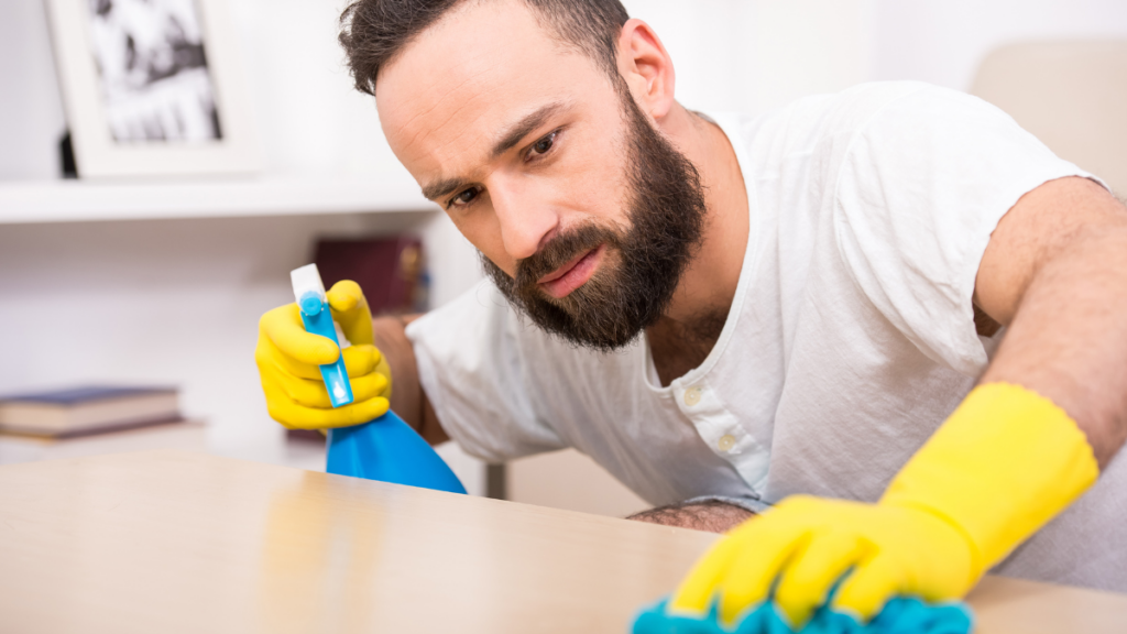 man cleaning counter