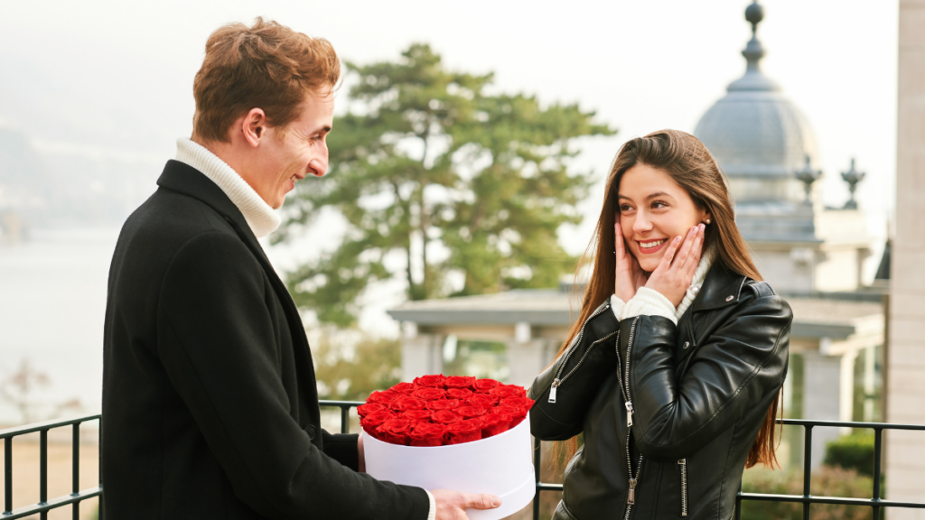 man giving smiling girl roses