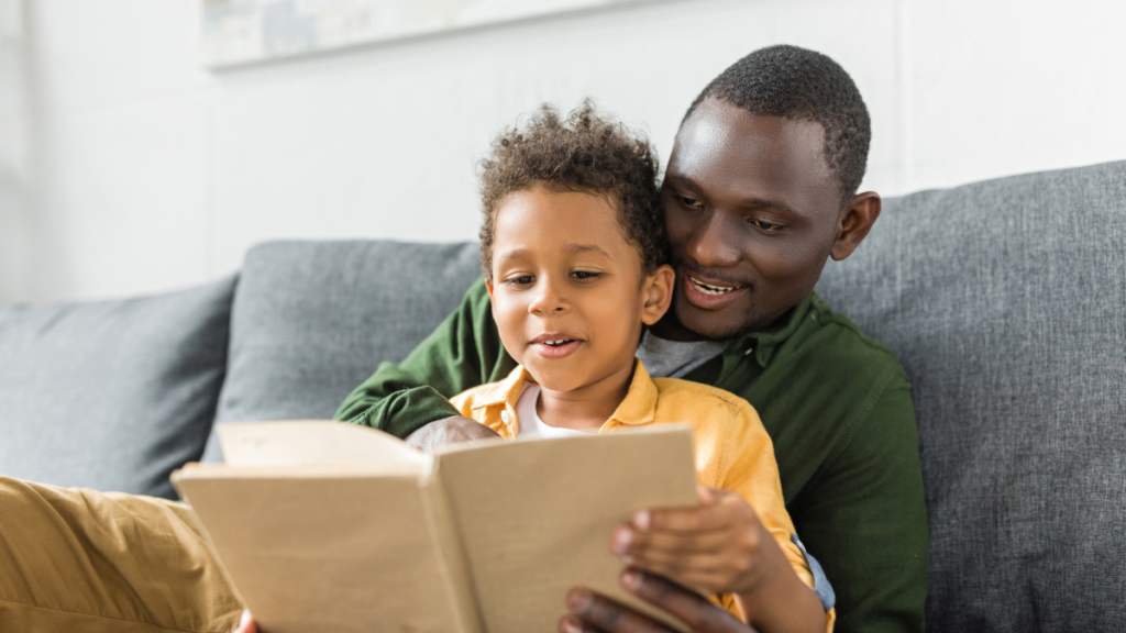 man reading a book with child