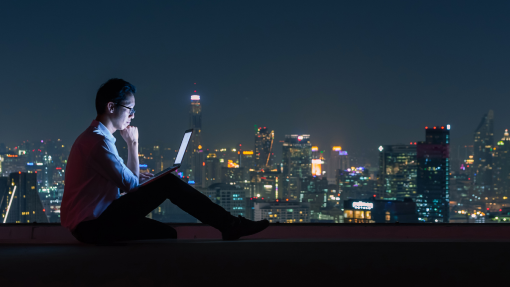 man sitting outside at night