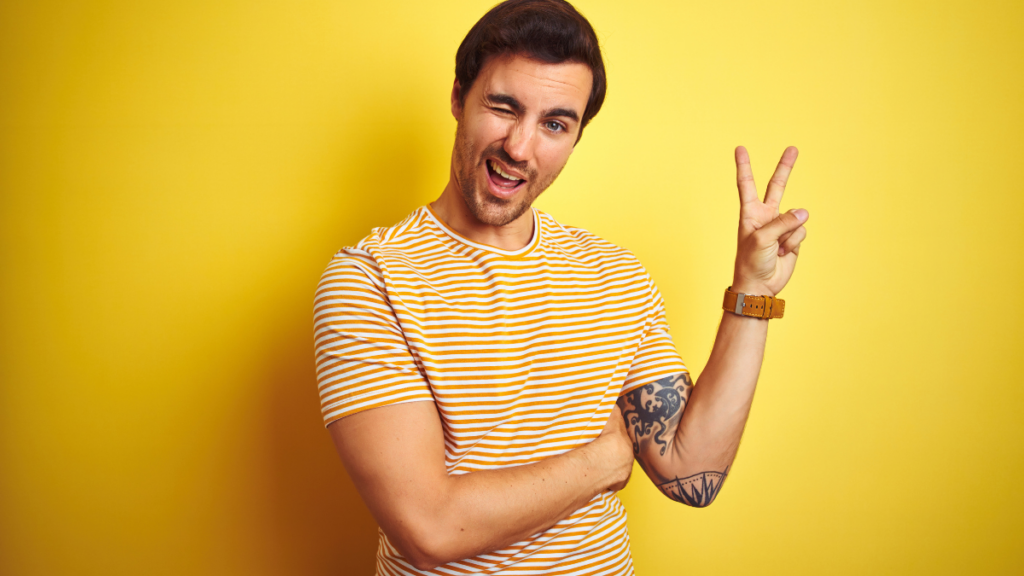 man winking and holding up peace sign