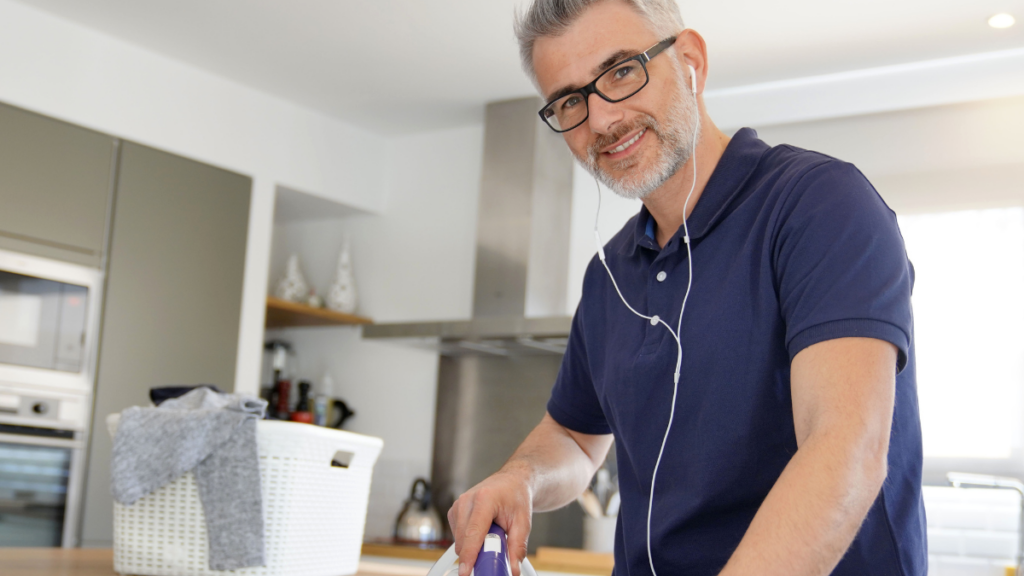 man with headphones in kitchen