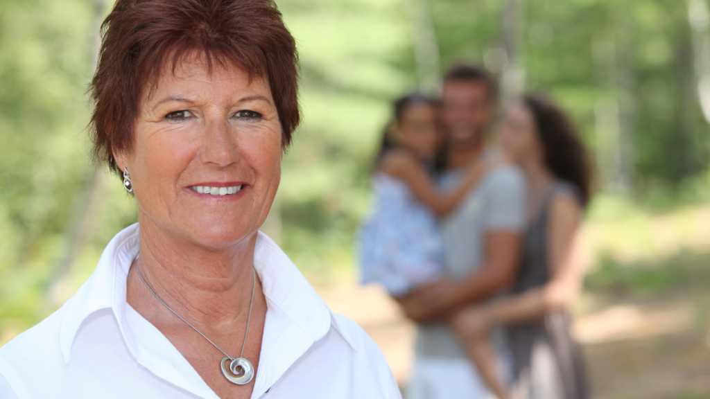 older woman with family behind