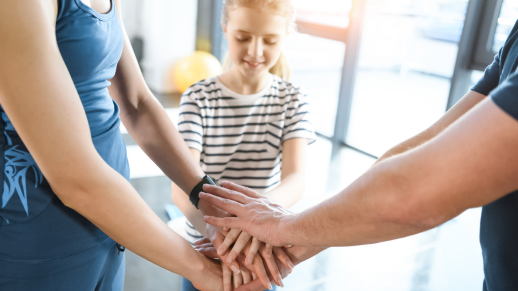 woman, man, and child with hands together