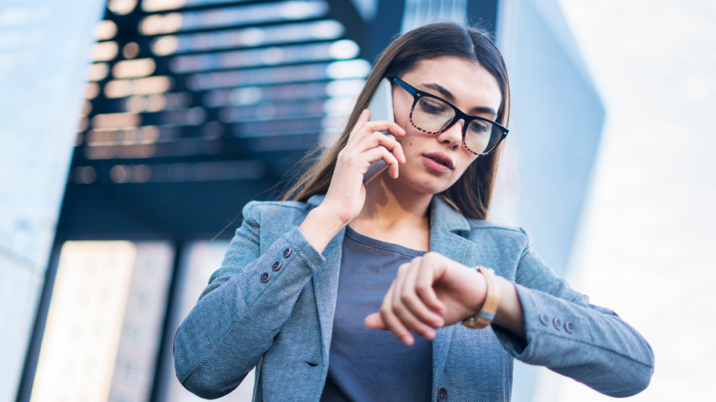 woman on phone looking at watch